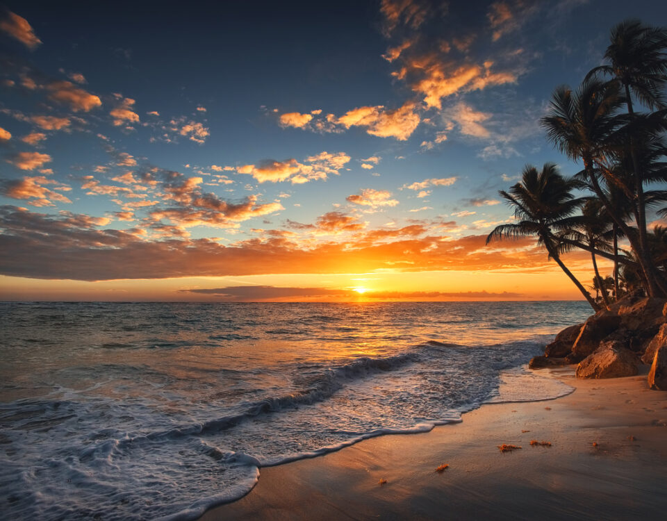 Sunrise on a Hawaiian island. Palm trees on sandy beach.